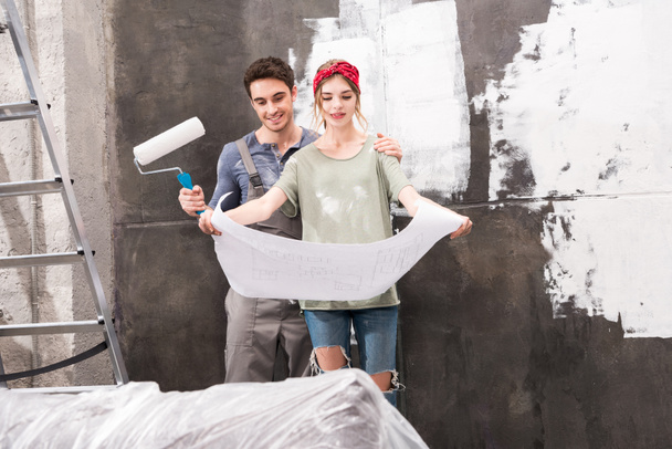 couple with schemes and paint roller - Foto, Imagem