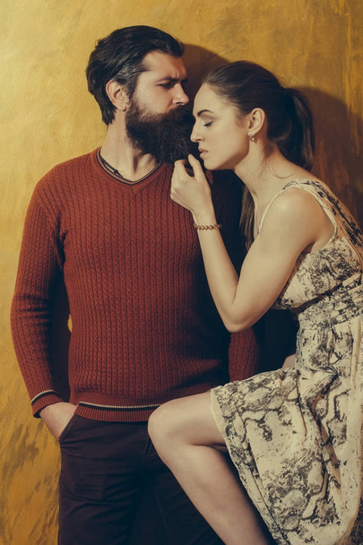 Pretty girl with closed eyes leaning on serious bearded man - Photo, Image