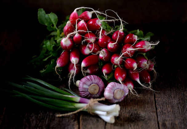Fresh organic radish with green onions and garlic. Healthy food. Rustic style. - Photo, Image