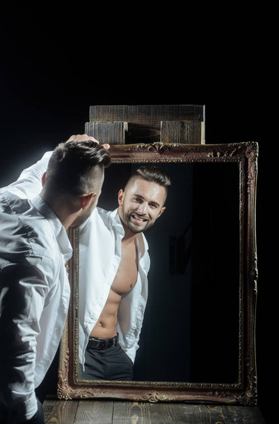 muscular macho man with sexy athlete body near vintage mirror - Photo, Image