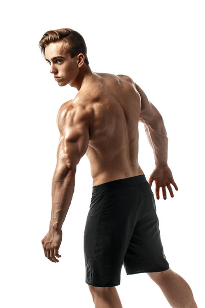 Back view of Unrecognizable man, strong muscles posing with arms down. Isolate - 写真・画像