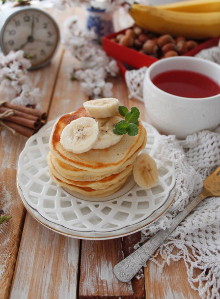 Banana pancakes for a breakfast on a white plate. Rustic style. - Photo, Image