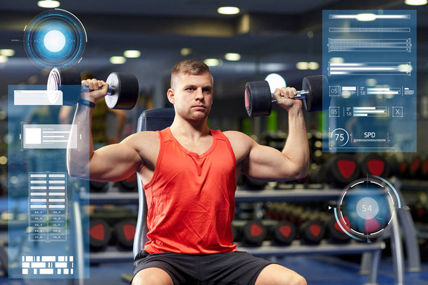young man with dumbbells flexing muscles in gym - Foto, Imagen