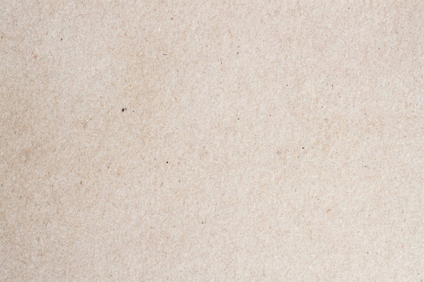 Paper texture cardboard background for design with copy space text or image. Recyclable material that looks virtually identical to the plain , but has small inclusions of cellulose - Photo, Image