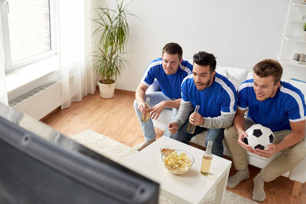 friends or football fans watching soccer at home - Фото, изображение