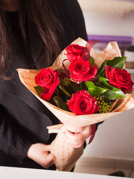 Florist making  bouquet of red roses - Photo, Image