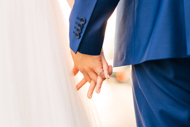 Bride and groom holding hands - Photo, Image