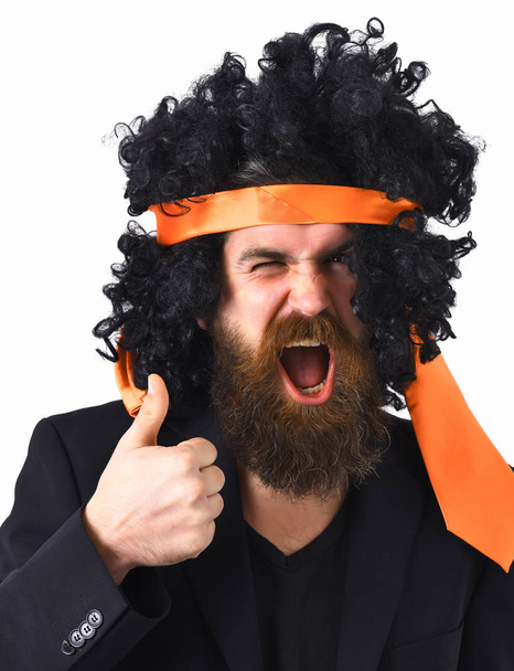 caucasian hipster in suit and black curly tie-tied afro wig - Foto, afbeelding