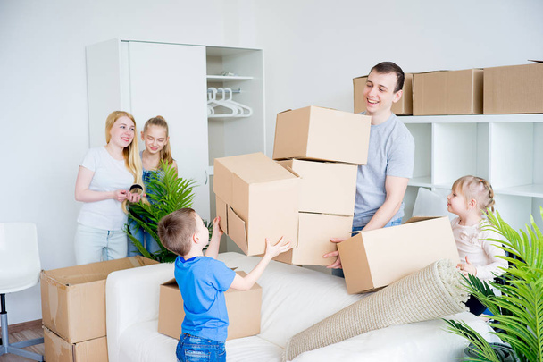 Family packing cardboard boxes - Фото, зображення