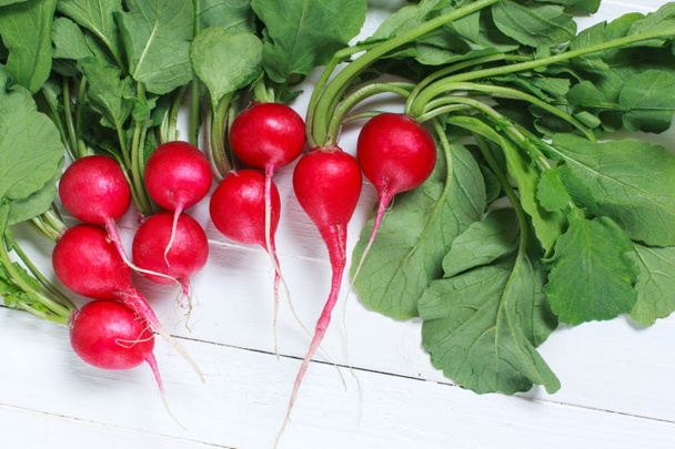 Bunch of fresh radishes on wooden table - Photo, Image