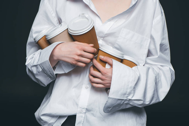 Woman holding pile of disposable coffee cups - Foto, afbeelding