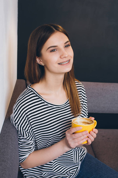Girl drinking coffee in a coffee shop - Zdjęcie, obraz