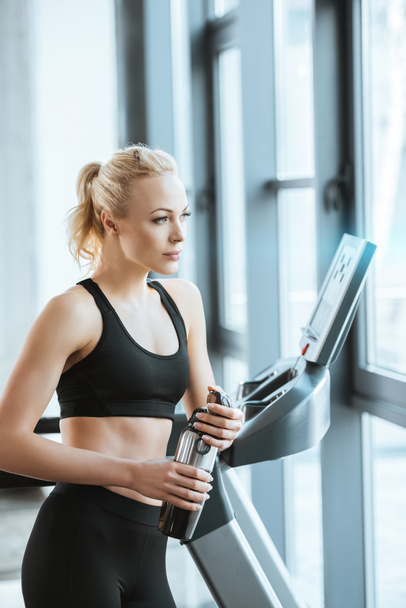 Young attractive woman resting after workout on treadmill  - Fotografie, Obrázek