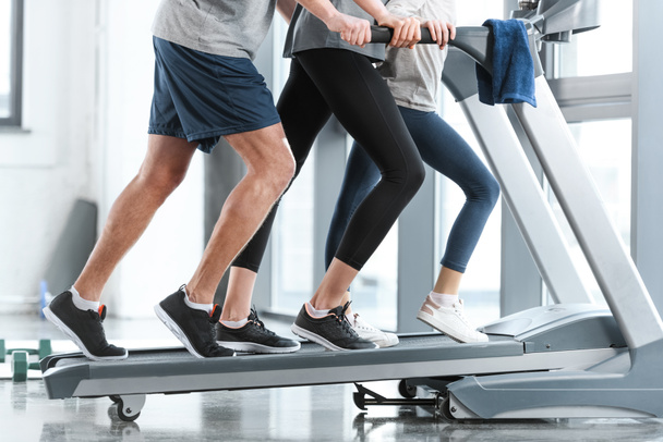Family workout on treadmill, side view  - Fotó, kép