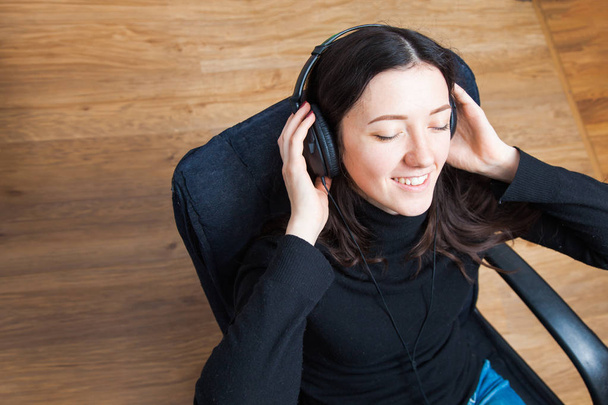 Young woman chilling at home in headphones. Relax with music - 写真・画像