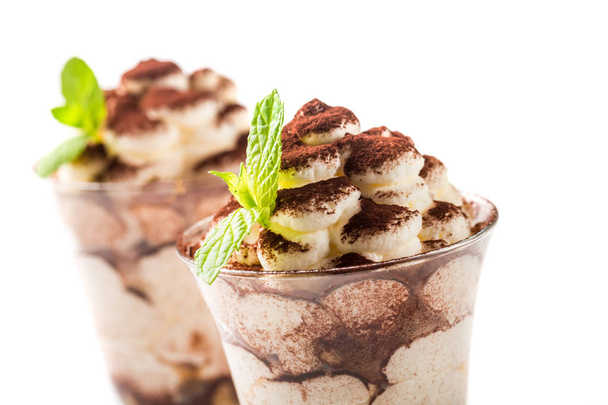 Closeup of tiramisu dessert with cocoa on a white background - Zdjęcie, obraz