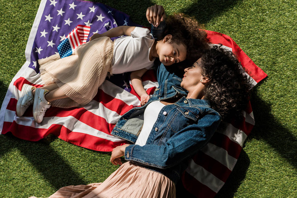 woman with daughter on american flag - Photo, Image