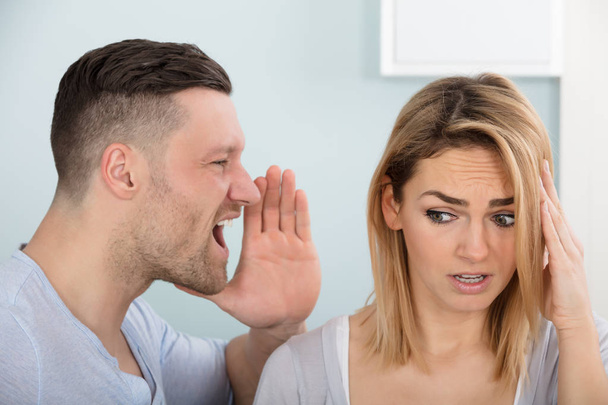Man Screaming In Wife's Ear - Фото, изображение