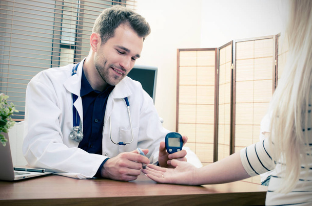 Doctor measuring of blood sugar for diabetes patient - Photo, Image