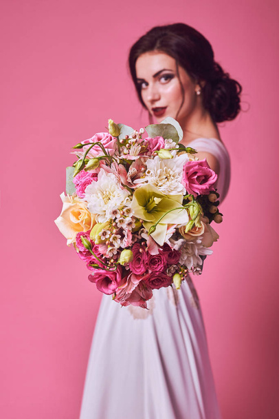 Brunet bride portrait in pink studio - Foto, imagen