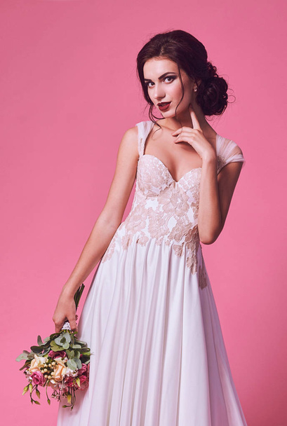 Brunet bride portrait in pink studio - Fotografie, Obrázek