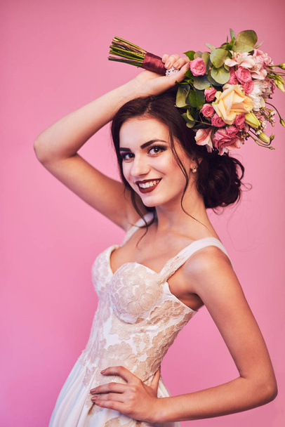 Brunet bride portrait in pink studio - Foto, Imagem