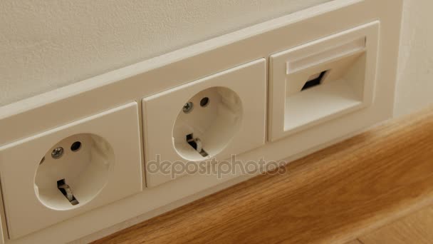 Close up of man hand putting plug in electricity socket. - Footage, Video