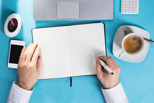 Businessman Writing On Notebook - Фото, зображення