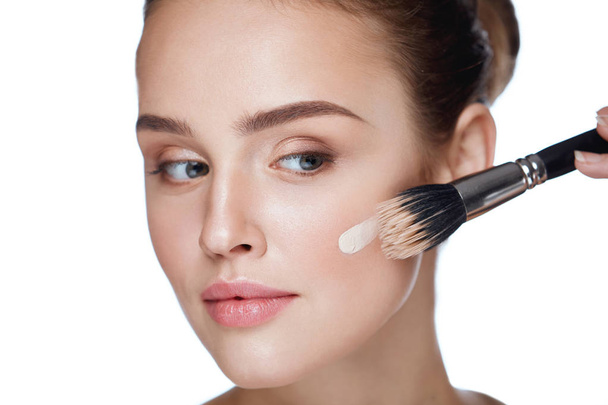 Woman Beauty Face Makeup. Female Applying Foundation - Foto, afbeelding
