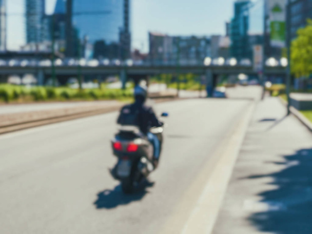 Blurred cityscape with riding motorcycle - Φωτογραφία, εικόνα