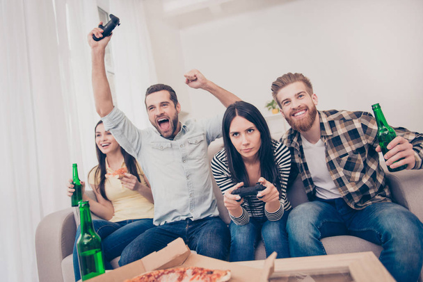 Young people having home party with video games, pizza and beer. - Foto, Bild
