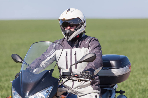 Biker riding on a motorcycle. Driving on a motorcycle tour journey - Photo, Image