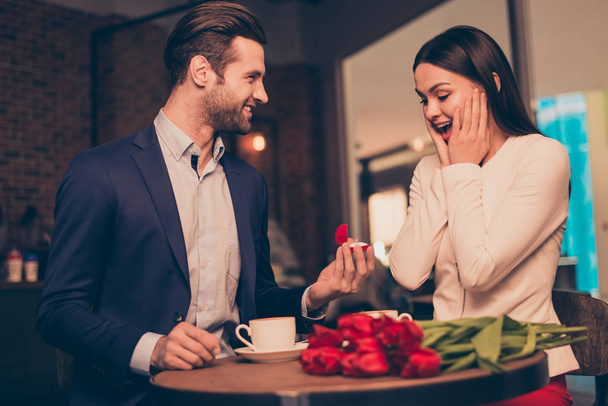 Making proposal in a cafe with ring and flowers - Foto, imagen