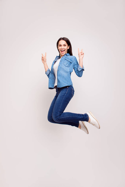 Positive young beautiful woman in casual clothing jumping up and - Foto, Imagem