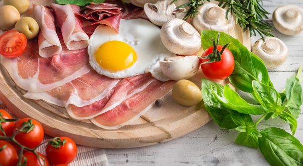 Healthy Mediterranean breakfast ingredients, ham, fried eggs, to - Photo, Image