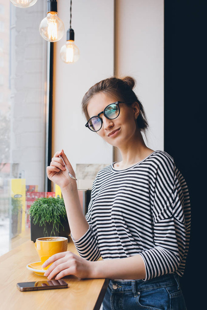 Girl in glasses drinking coffee  - Φωτογραφία, εικόνα