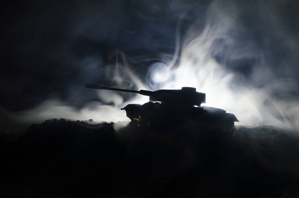 Tanks in the conflict zone. The war in the countryside. Tank silhouette at night. Battle scene. - Фото, изображение