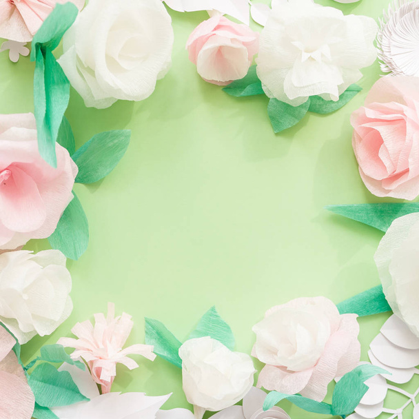 Round frame with color paper flower on green background. - Photo, Image