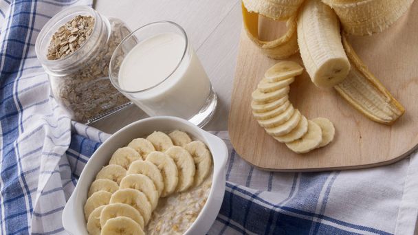 oatmeal with bananas and a glass of milk - Photo, Image