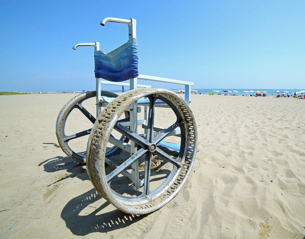 fauteuil roulant avec de grandes roues en acier pour aller sur le sable
 - Photo, image