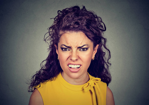 Closeup of an angry furious woman  - Photo, image