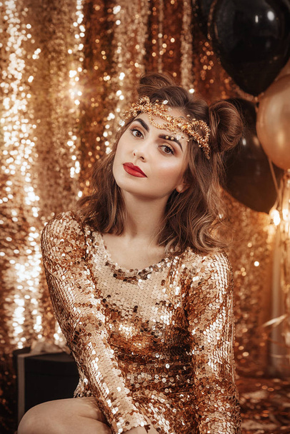 Beautiful  young woman  in golden dress - Foto, Imagen