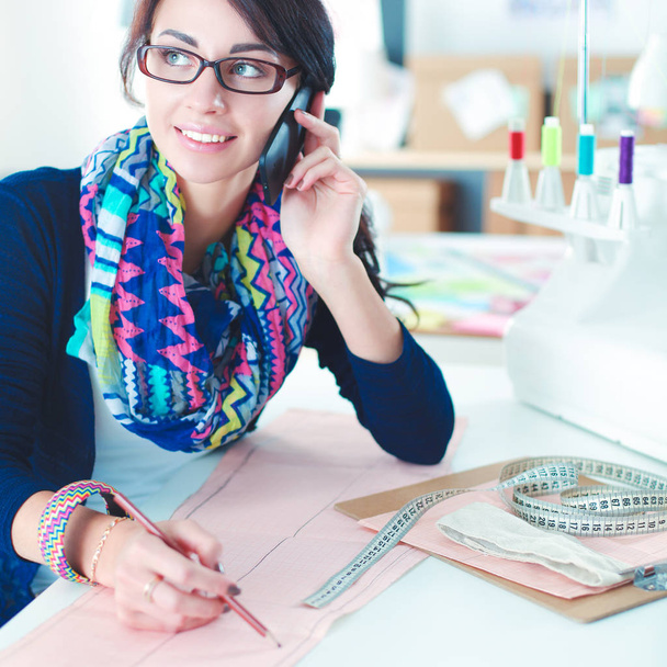 Young dressmaker designing clothes pattern on paper - Φωτογραφία, εικόνα