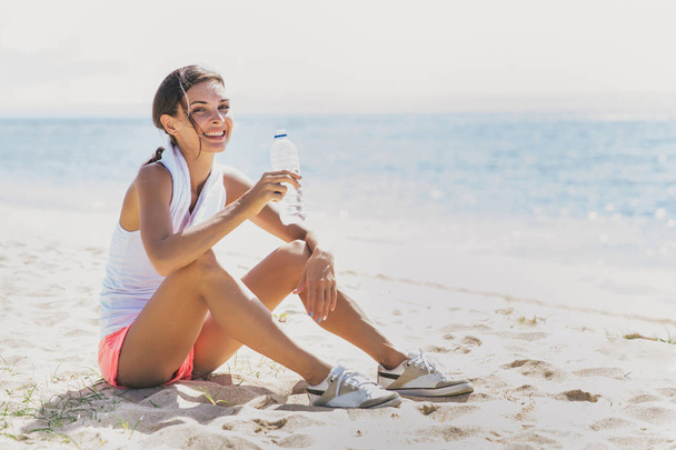 healthy woman taking a rest after workout - Photo, Image