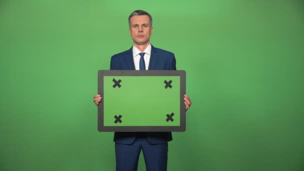 Young male holding chromakey board - Footage, Video