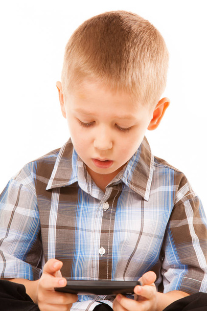 Little boy playing games on smartphone - Фото, зображення