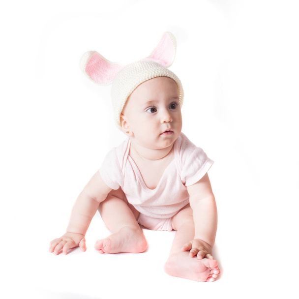 Baby girl in a rabbit hat - 写真・画像