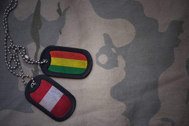 army blank, dog tag with flag of bolivia and peru on the khaki texture background. military concept - Photo, Image