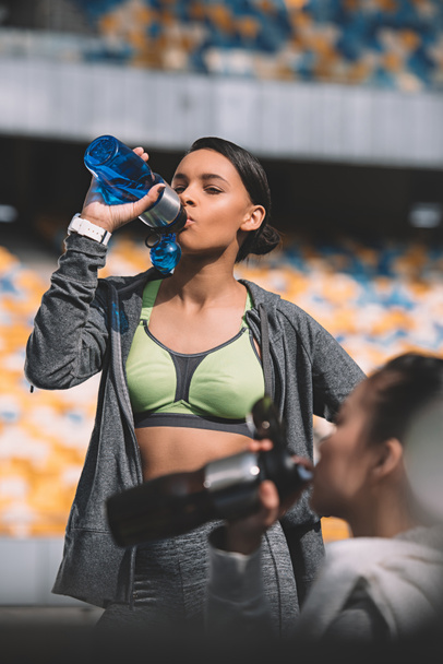 Sportswoman drinking water   - Photo, image