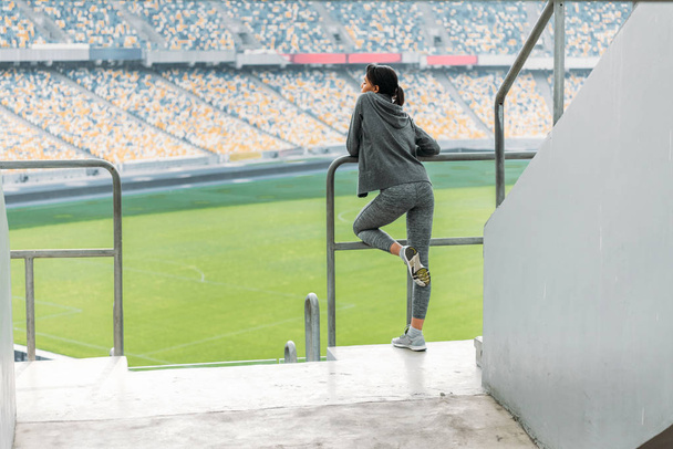sportswoman at handrail on stadium  - Foto, Imagen
